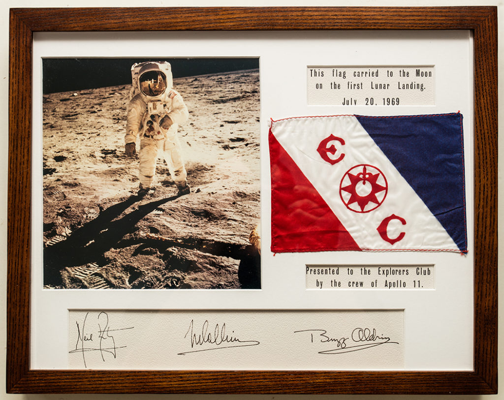 An image of the Apollo 11 moon landing with the miniature Explorers Club Flag carried on that mission in the pocket of Neil Armstrong’s spacesuit. The Explorers Club Research Collections.