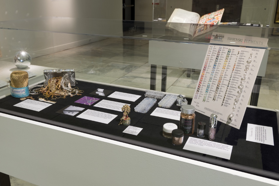 "conservation case" section of in-person All that Glitters exhibition featuring glitter makeup and Swarovski crystal chart