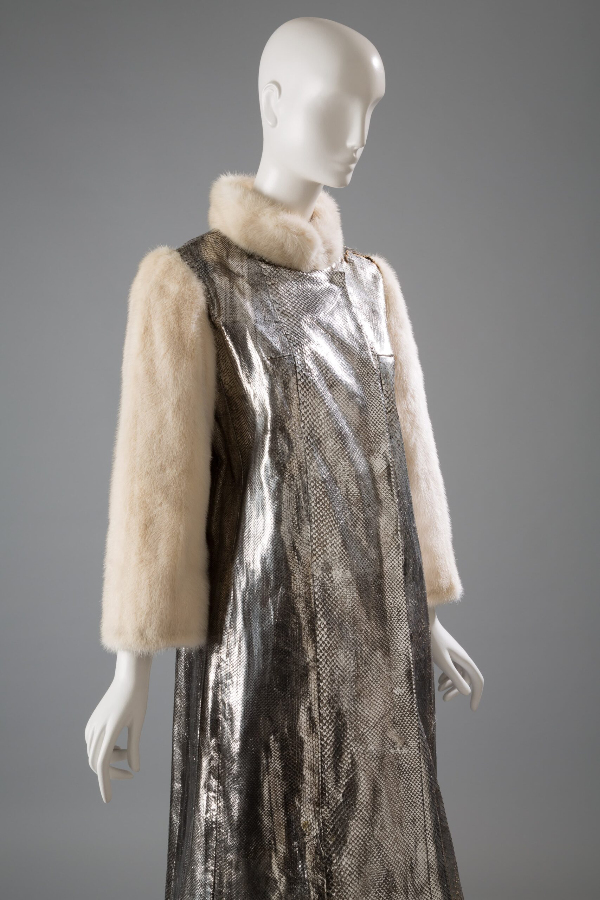 Long silver snakeskin coat with white mink fur long sleeves and collar. Coat has overlapping front with no visible closures.