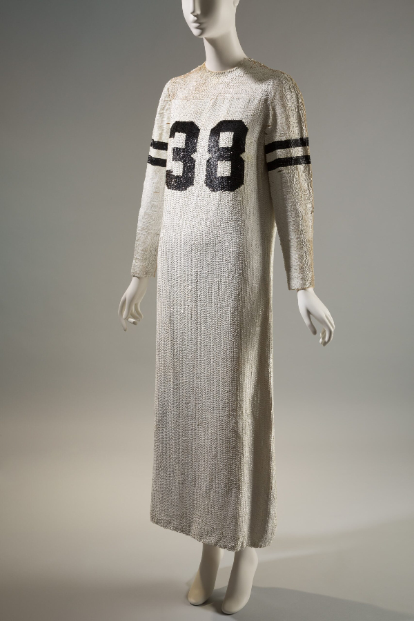 Long sleeve, floor length, fully sequined evening gown made in style of sports jersey with the number 38 at front and 2 black bands on upper sleeves.
