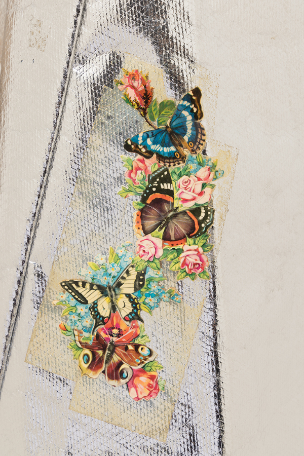 View of applied paper flower and butterfly motifs on silver Mylar dress