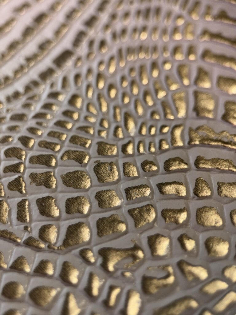Embossed vinyl in gold and white