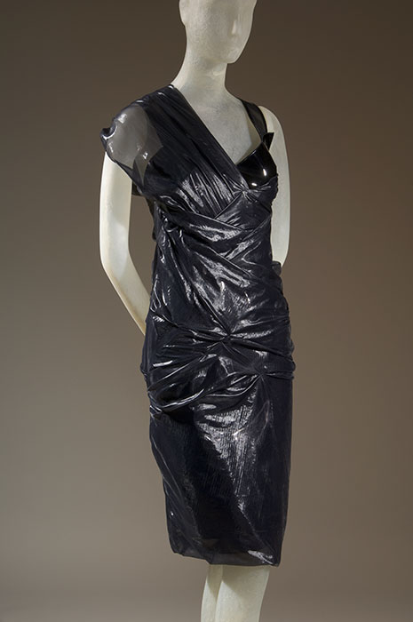 Balenciaga (Nicolas Ghesquière) Evening dress. This evening dress bears little resemblance to the Perfecto, but it was inspired by The Terminator, a science fiction movie featuring a cyborg wearing a biker jacket. Designer Nicolas Ghesquière combined references to 1950s couture with the imagery of cars and cyberculture, creating a futuristic twist on an elegant staple. Black patent leather and silk enamel, Spring 2007, France, 2007.44.1, gift of Balenciaga