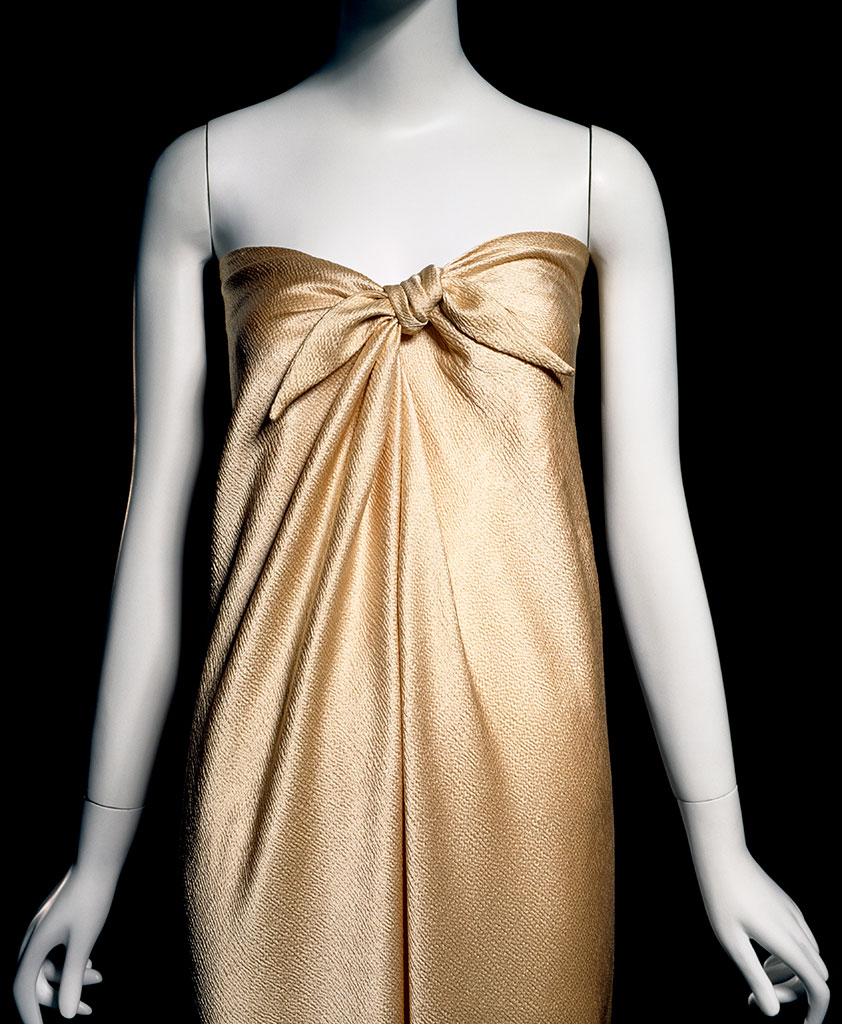 (detail) Halston, “sarong” dress, gold hammered silk satin, 1976, USA, 82.3.9, gift of Frederick Supper