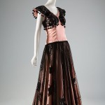 Pink and Black | Balenciaga’s friend, Ana de Pombo, a Spaniard who designed for the House of Paquin, was inspired by flamenco dress— and possibly also by Picasso’s costumes for The Three-Cornered Hat (1919), which featured Tamara Karsavina in a lingerie pink dress trimmed with black lace. Paquin Rayon satin dress, circa 1946 The Museum at FIT, 76.172.1 Gift of Rosita Montenegro De Haan
