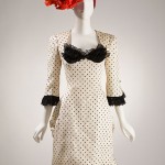 A Theatrical Sensibility | Christian Lacroix’s fashions have always been theatrical. This ensemble, created for Patou the year before he opened his own couture house, demonstrates why he would later be so successful as a costume designer for ballets such as Gaité Parisienne. Christian Lacroix Dress, hat, 1986 Lent by the Beverley Birks Collection