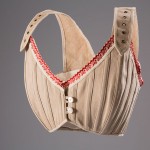 Bust supporters and proto-brassieres re-emerged as the fashionable silhouette changed during the late nineteenth century. They were able to lift and enhance the breasts in ways that were not possible with traditional corsetry. While bust supporters took a variety of forms, this example would have helped to create the fashionable “monobosom” silhouette of the early twentieth century. Natural linen, cotton trim, circa 1905, France, 98.29.5, museum purchase