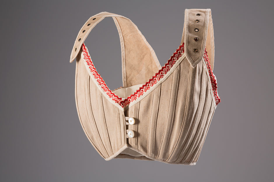 Bust supporters and proto-brassieres re-emerged as the fashionable silhouette changed during the late nineteenth century. They were able to lift and enhance the breasts in ways that were not possible with traditional corsetry. While bust supporters took a variety of forms, this example would have helped to create the fashionable “monobosom” silhouette of the early twentieth century. Natural linen, cotton trim, circa 1905, France, 98.29.5, museum purchase