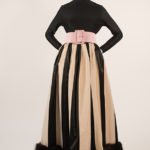 black and white striped skirt with fur trim paired with long sleeve black turtle neck and pink belt at waist