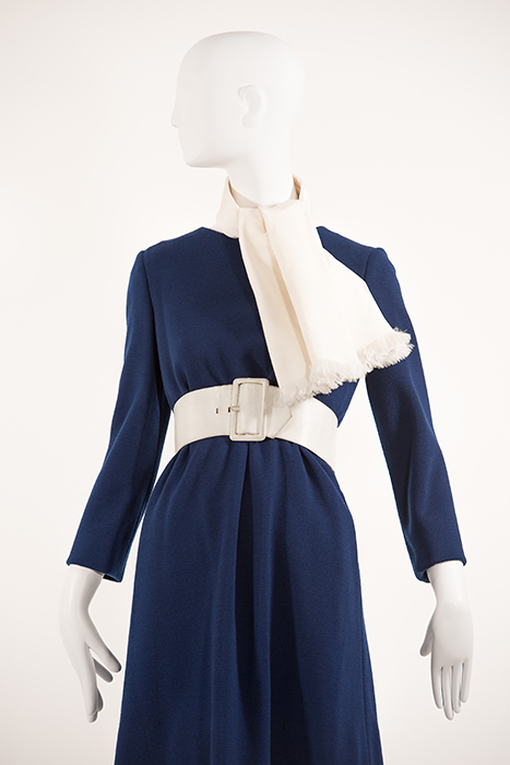 navy blue wool dress with ivory belt around waist and ivory scarf around neck