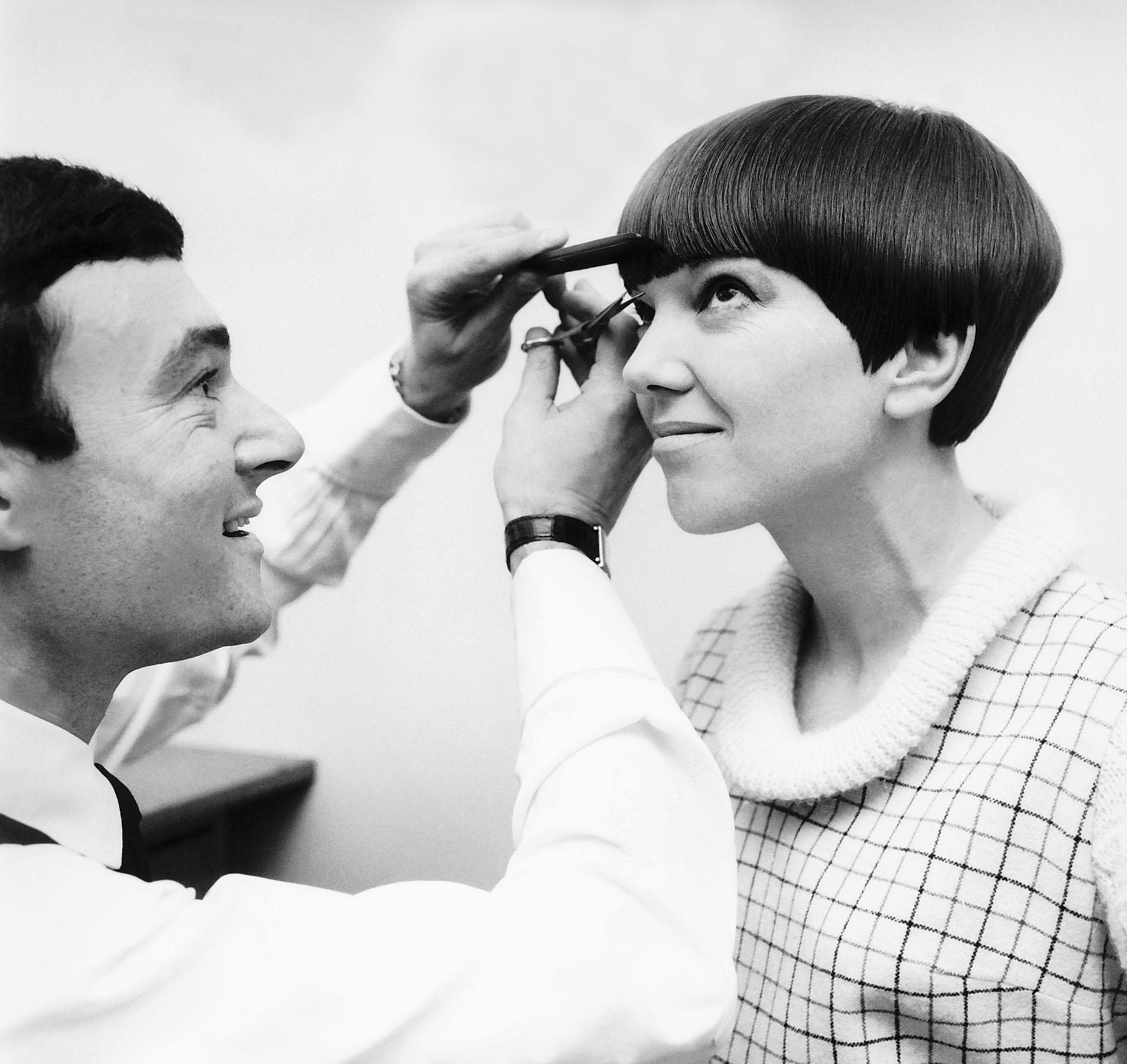 Vidal Sasoon trims the bangs of designer Mary Quant's  short haircut, 1966