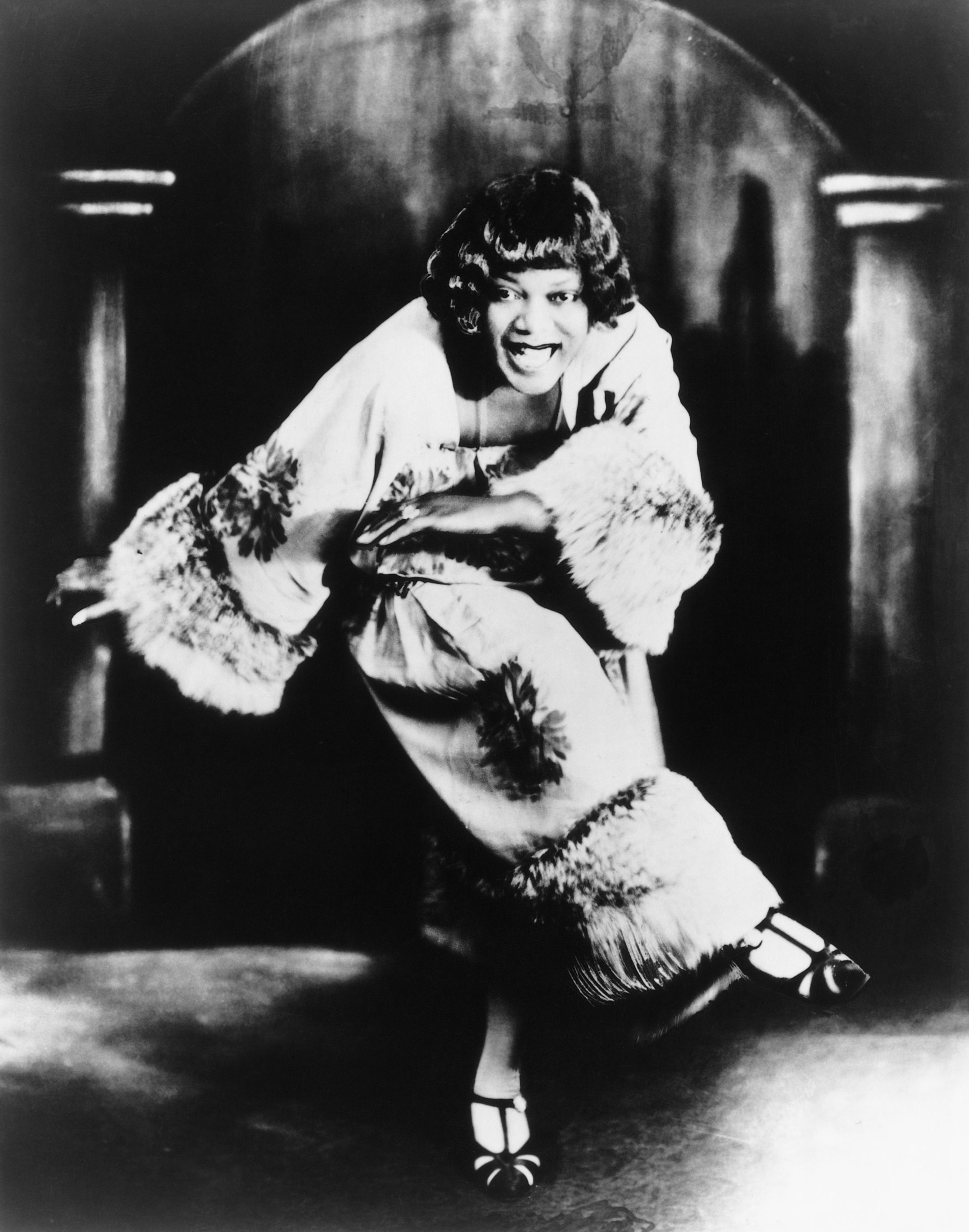 Bessie Smith, a renowned Jazz age singer, dances as she faces the camera straight on, circa 1920