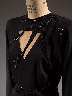 detail of black silk Adrian dress .